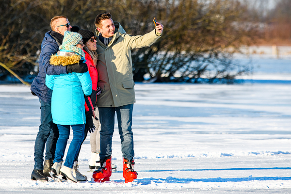 Youngsters taking selfies on skates on natural ice